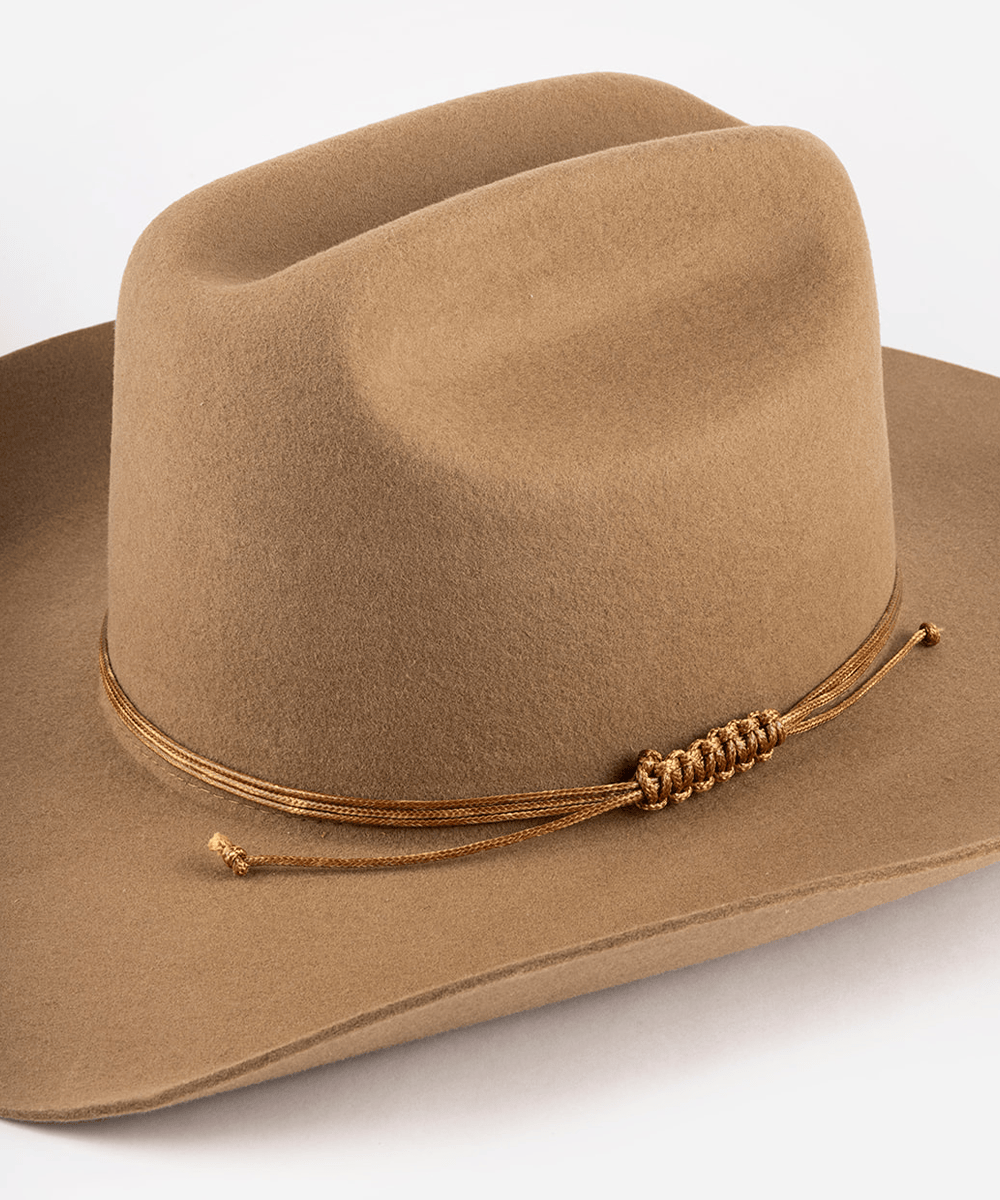 Brown cowboy hat with a braided band on a white background #color_brown