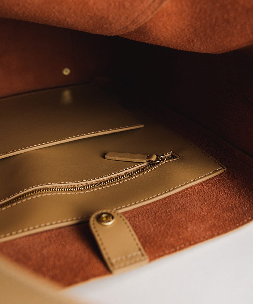 The inside pocket of a tan Dia Everyday Leather Tote Bag  #color_tan