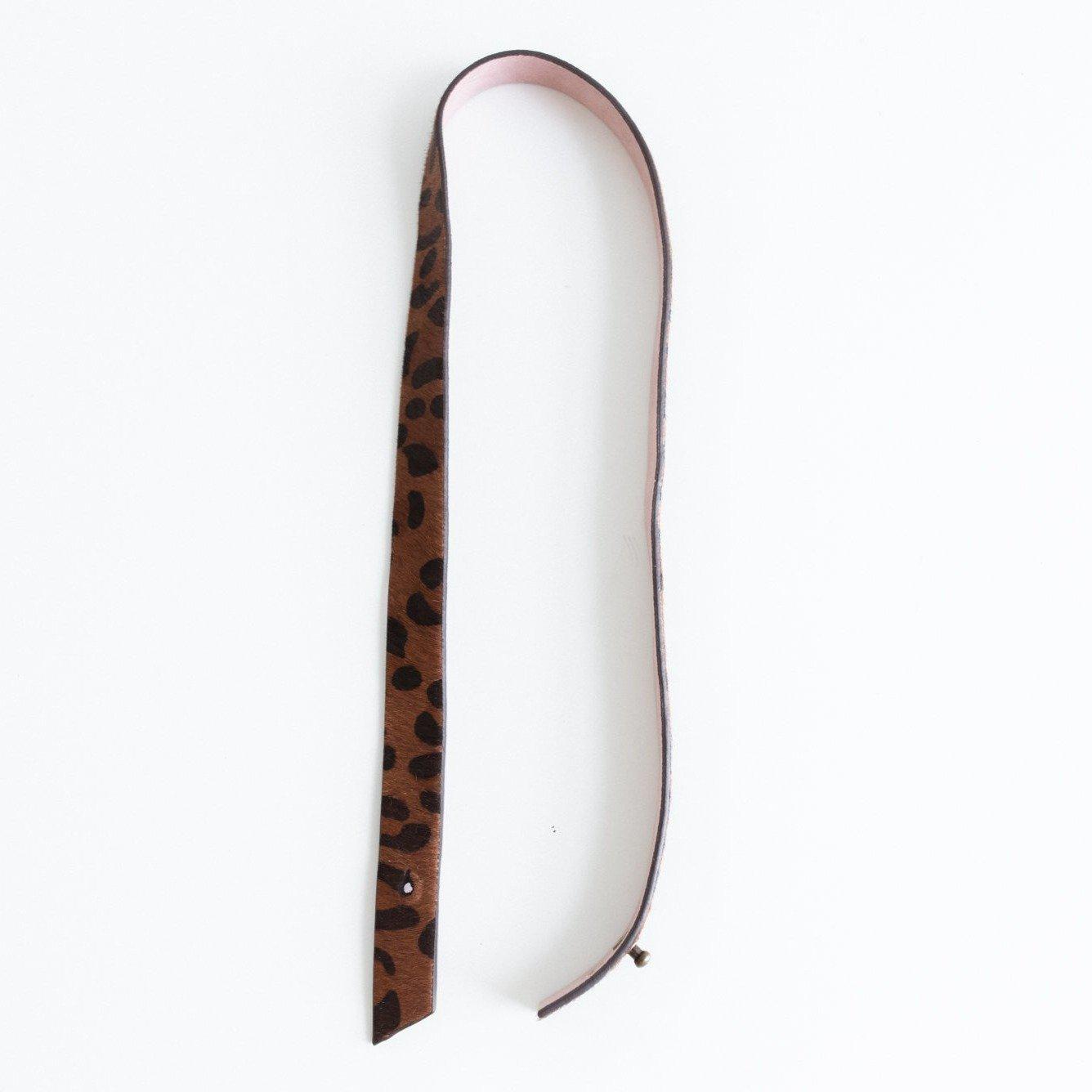 A dark brown leopard print hat band on a plain background #color_dark brown