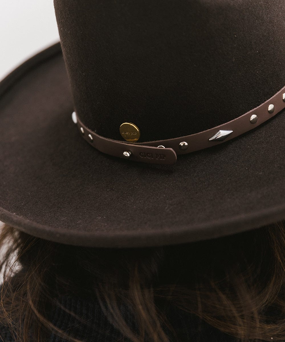 Close up image of a brown hat with a chocolate colored studded leather hat band against a plain background #color_chocolate