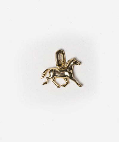 A gold horse hat charm on a plain background #color_gold