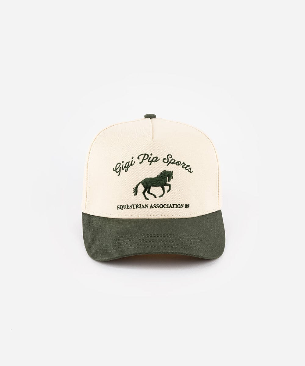 A cream and dark green Trucker hat with 'Gigi Pip Sports' and horse logo on a white background  #color_cream - dark green