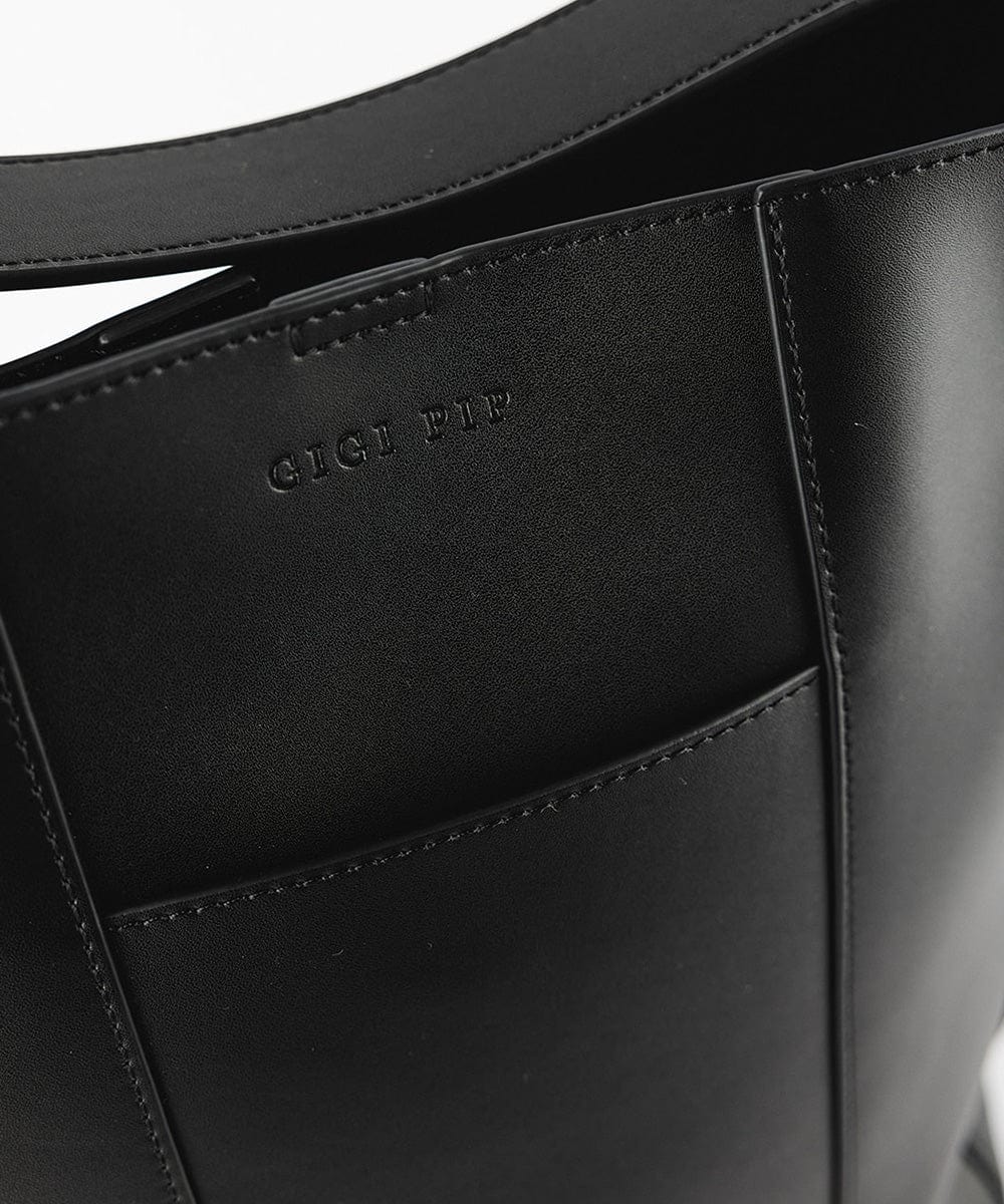 Close up image of a black Dia Everyday Leather Tote Bag  against a plain background #color_black