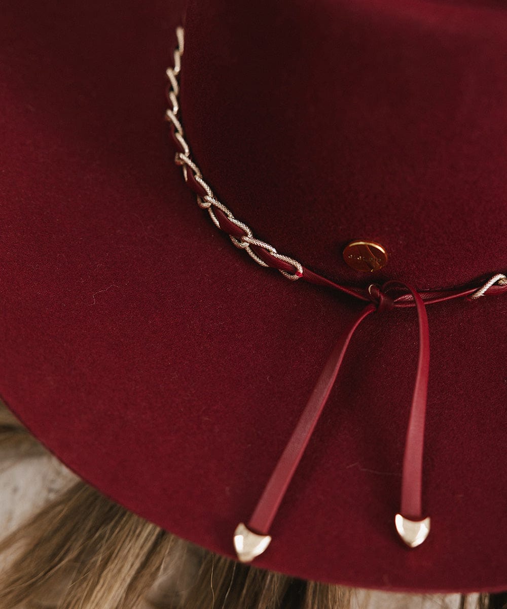 A burgundy colored felt hat with a metallic chain detail on the band #color_burgundy