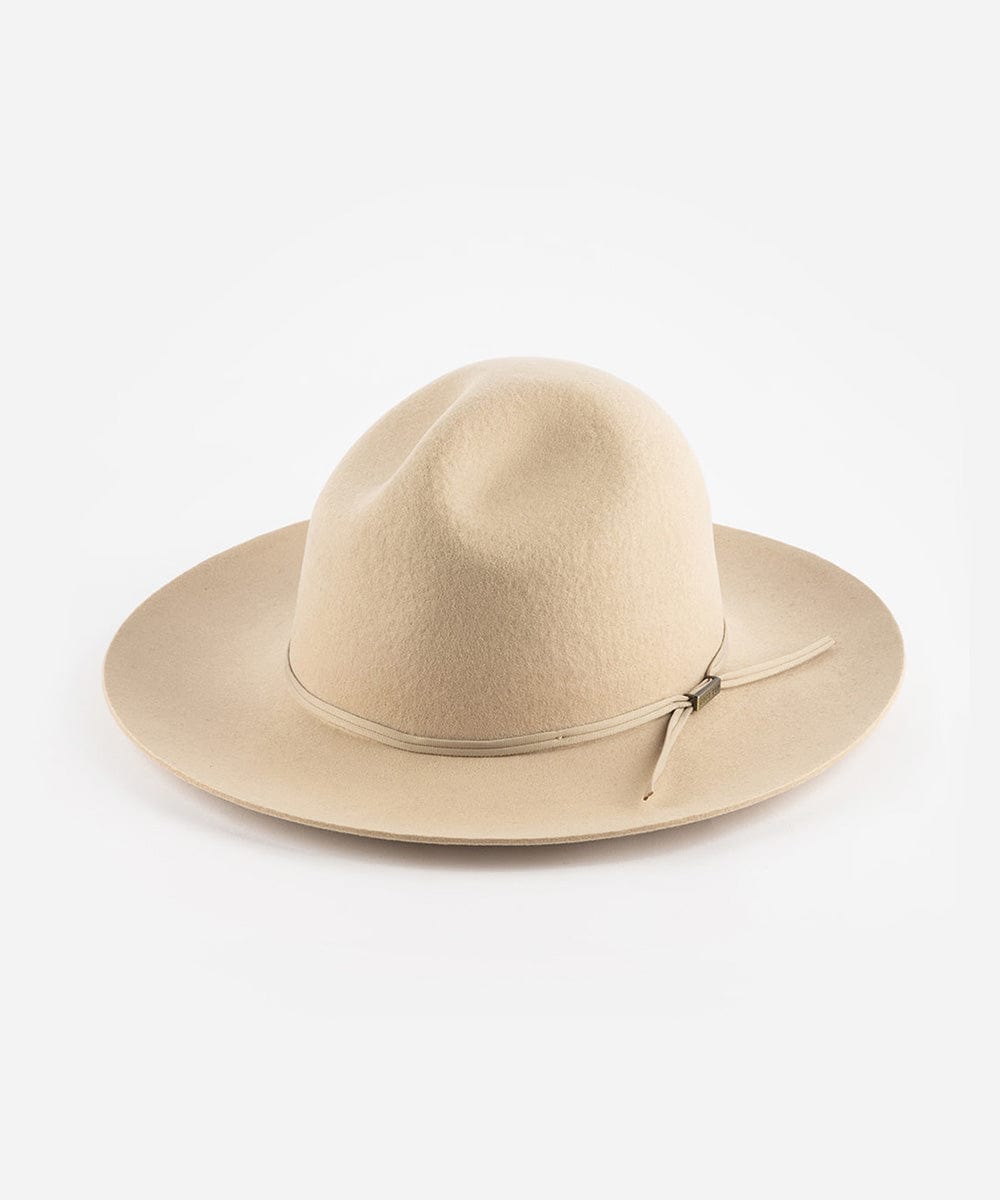 A cream fedora hat with a hat band on a plain background #color_cream