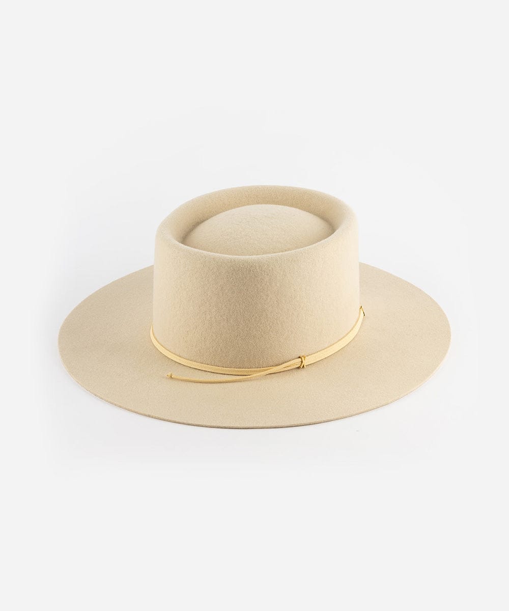 A cream Maise classic flat brim hat with a telescope crown and a brown band on the brim, displayed against a white background. #color_cream