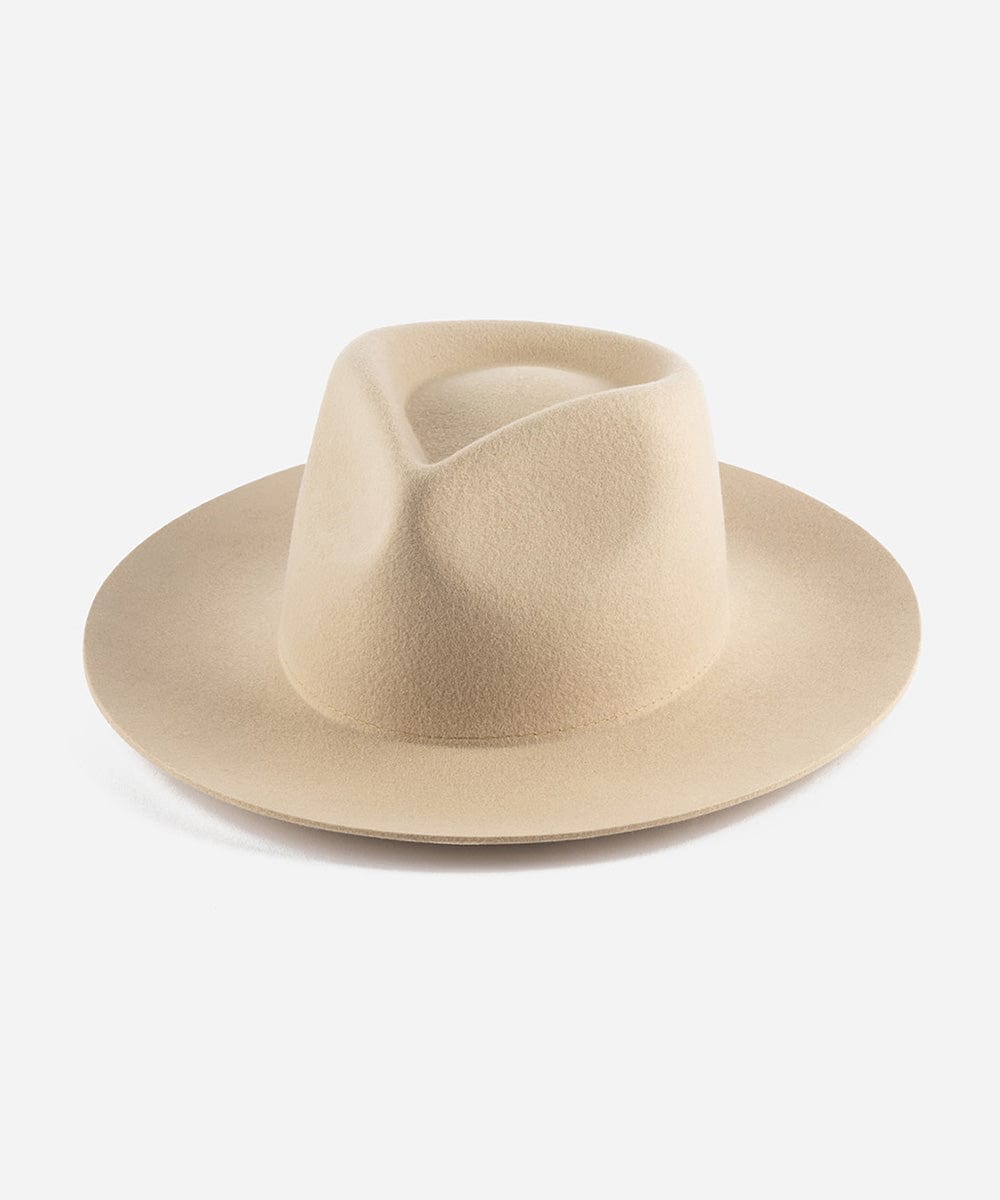 A cream fedora hat with a teardrop shaped crown and a stiff, medium upturned brim made of felt. #color_cream