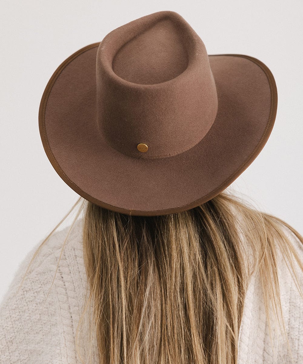 Person wearing a chocolate colored felt western hat facing behind against a white background #color_chocolate