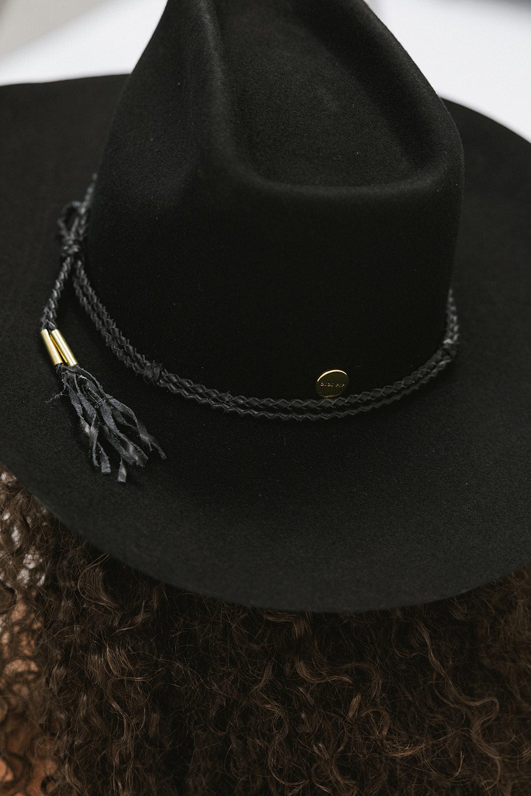A black cowboy hat with a black hat band #color_black