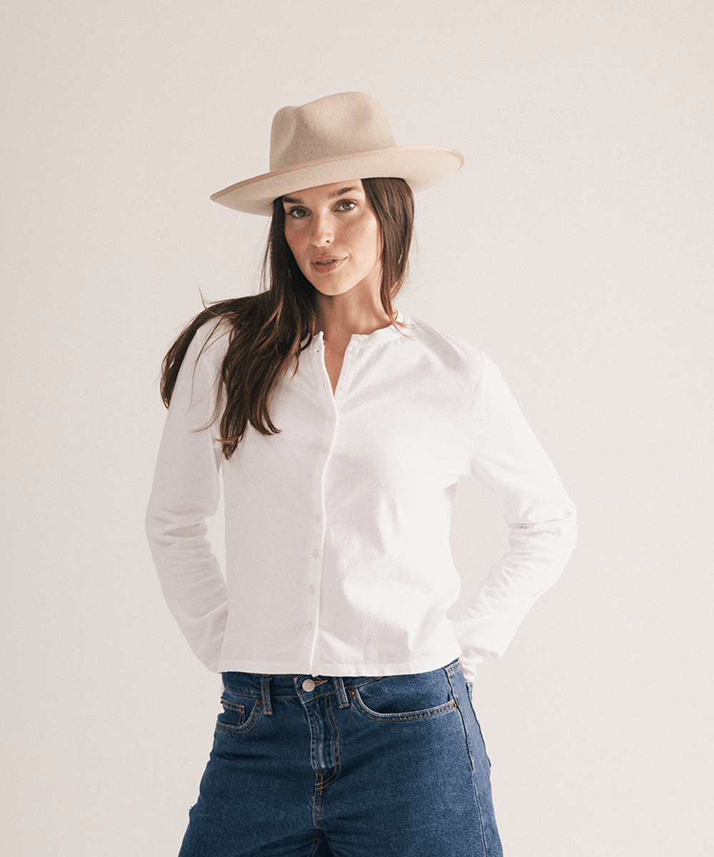 Woman wearing a fedora hat with a band on a white background #color_oatmeal