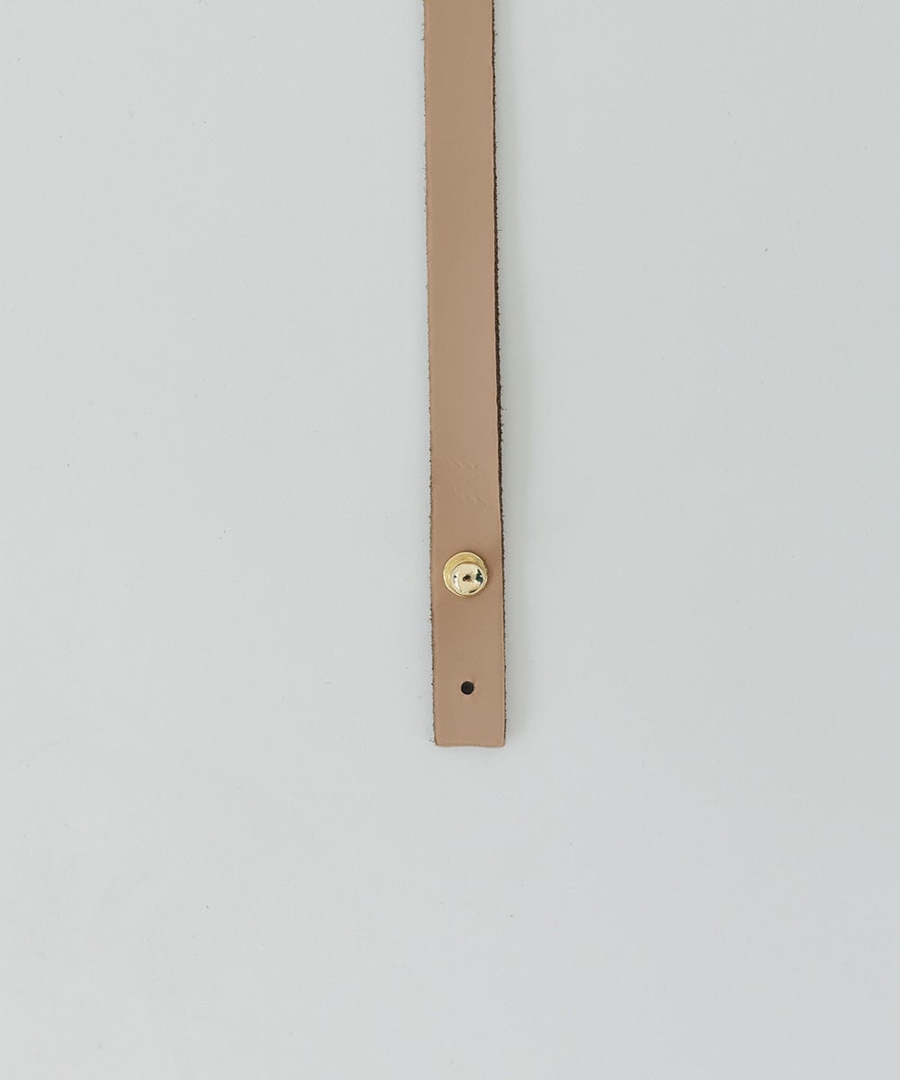 A tan genuine leather thin hat band with a pin on a white background #color_tan