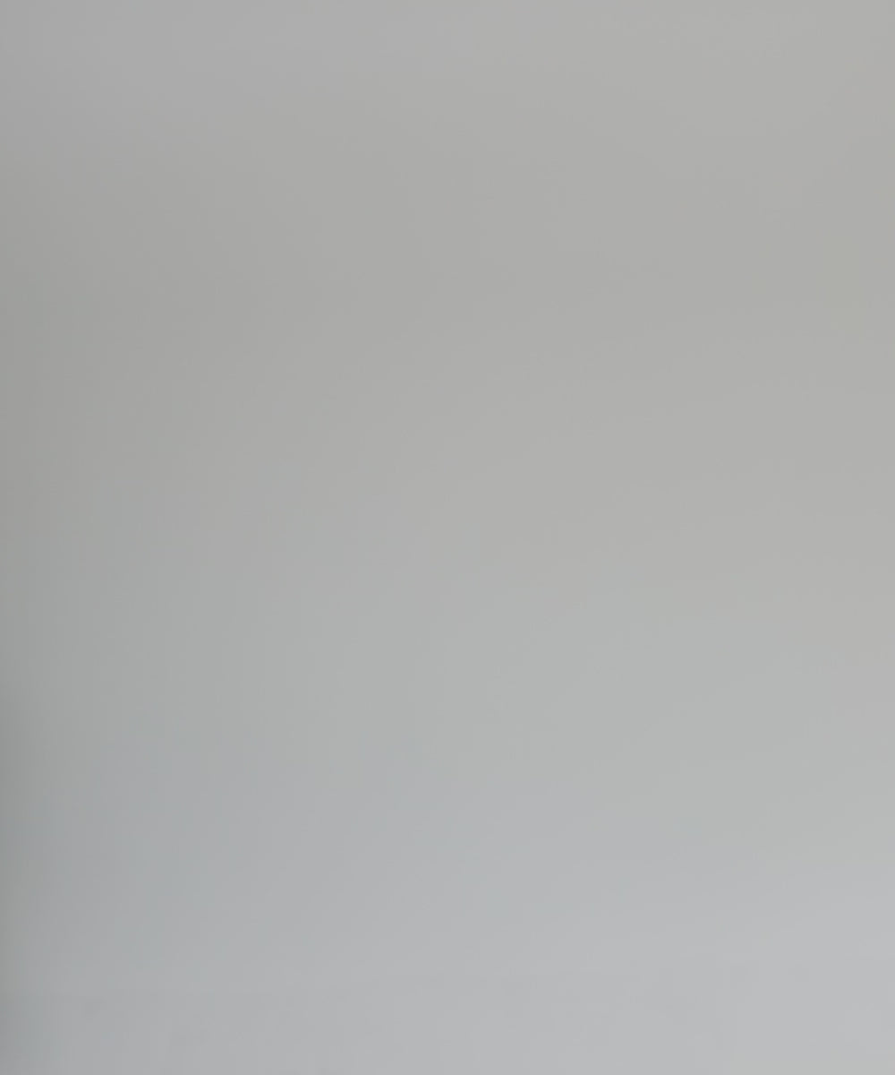 Woman wearing a black pencil brim fedora hat, white shirt and white pants, posing against a plain background #color_black