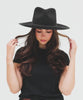 Woman wearing a mix charcoal  colored Rowan Wide Brim Fedora Hat with a hat band and a black t-shirt against a plain background  #color_mix charcoal