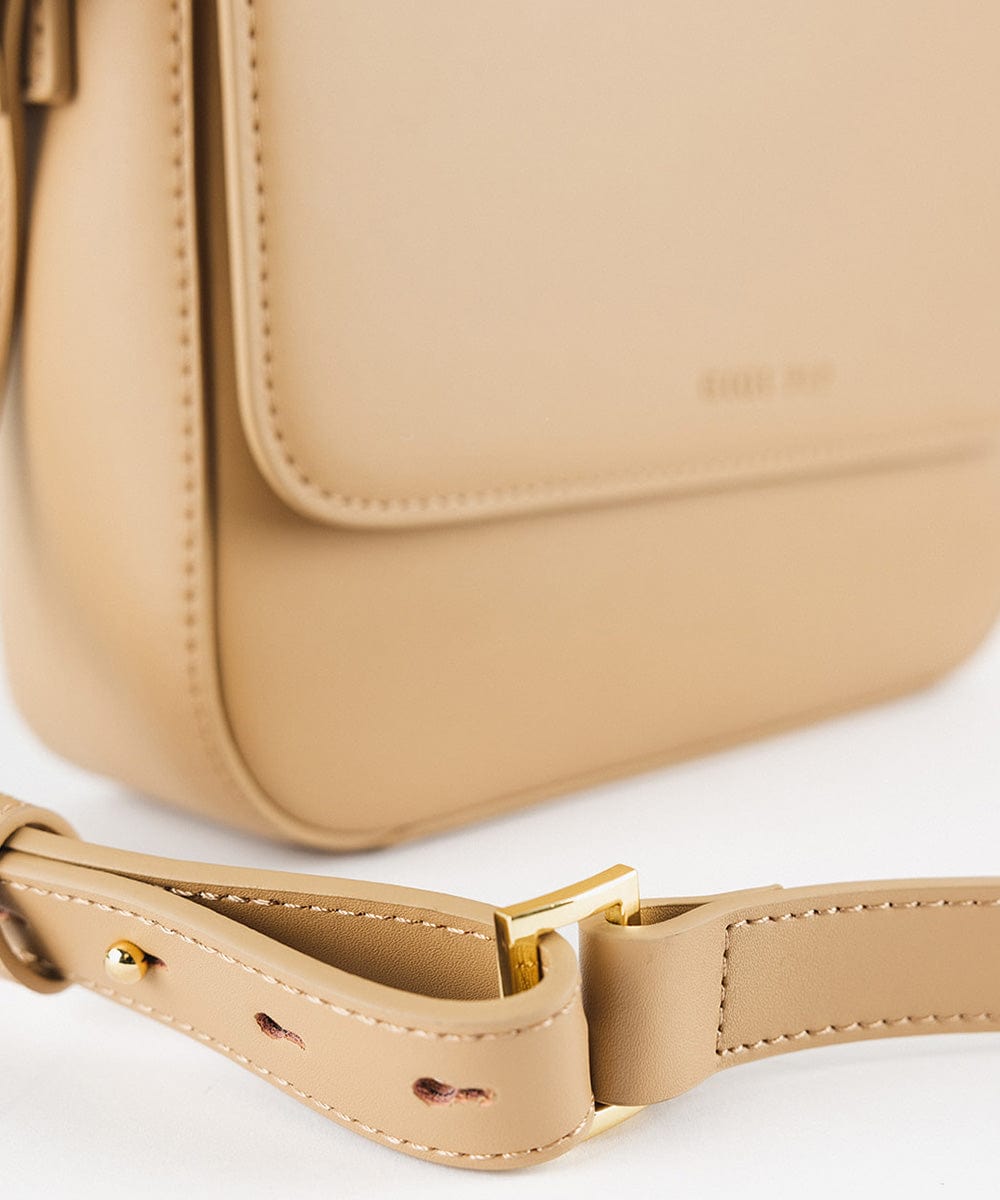 A tan Rhys Crossbody Genuine Leather Bag on a plain background  #color_tan
