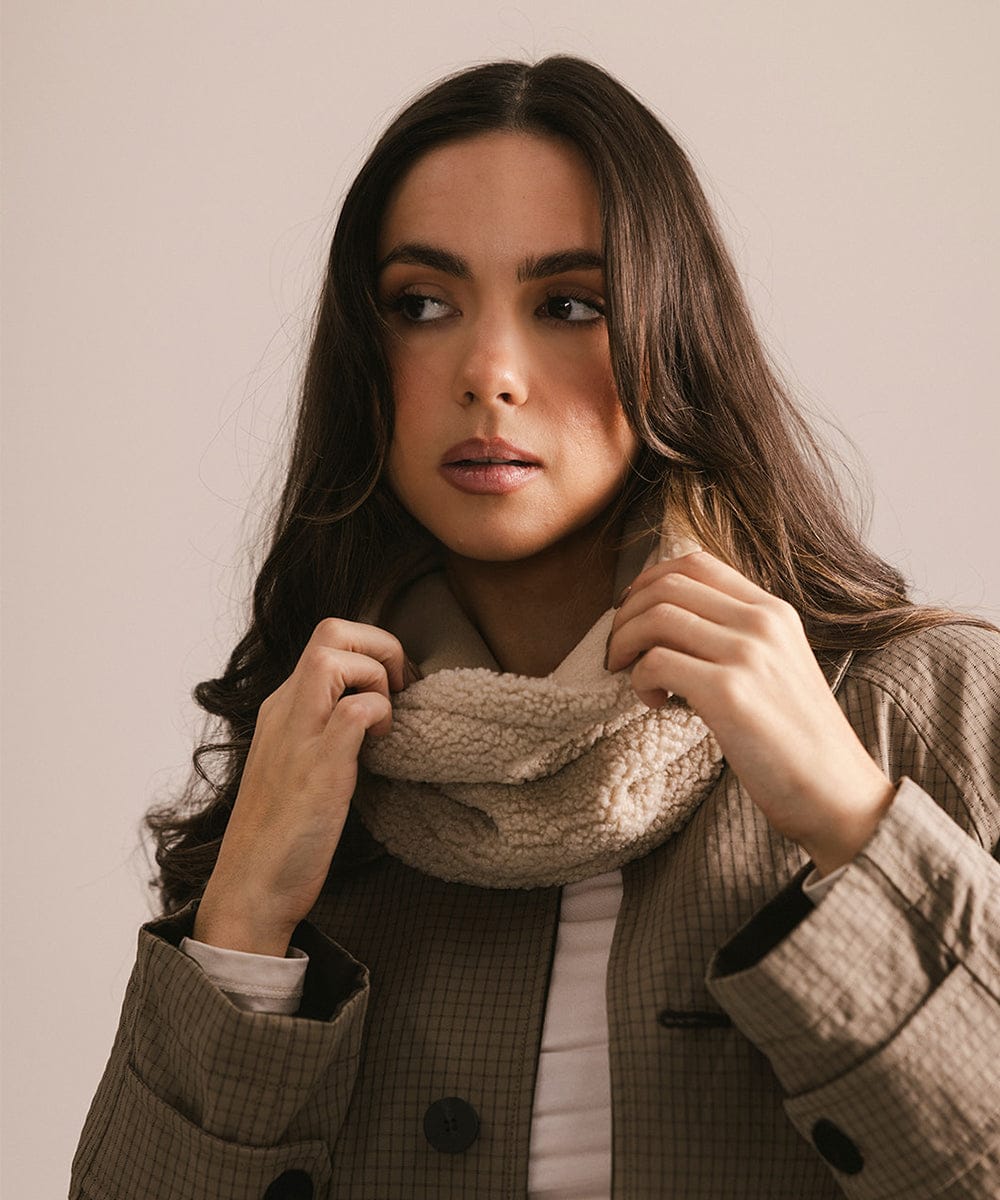 Woman wearing a coat and scarf against a plain background #color_cream