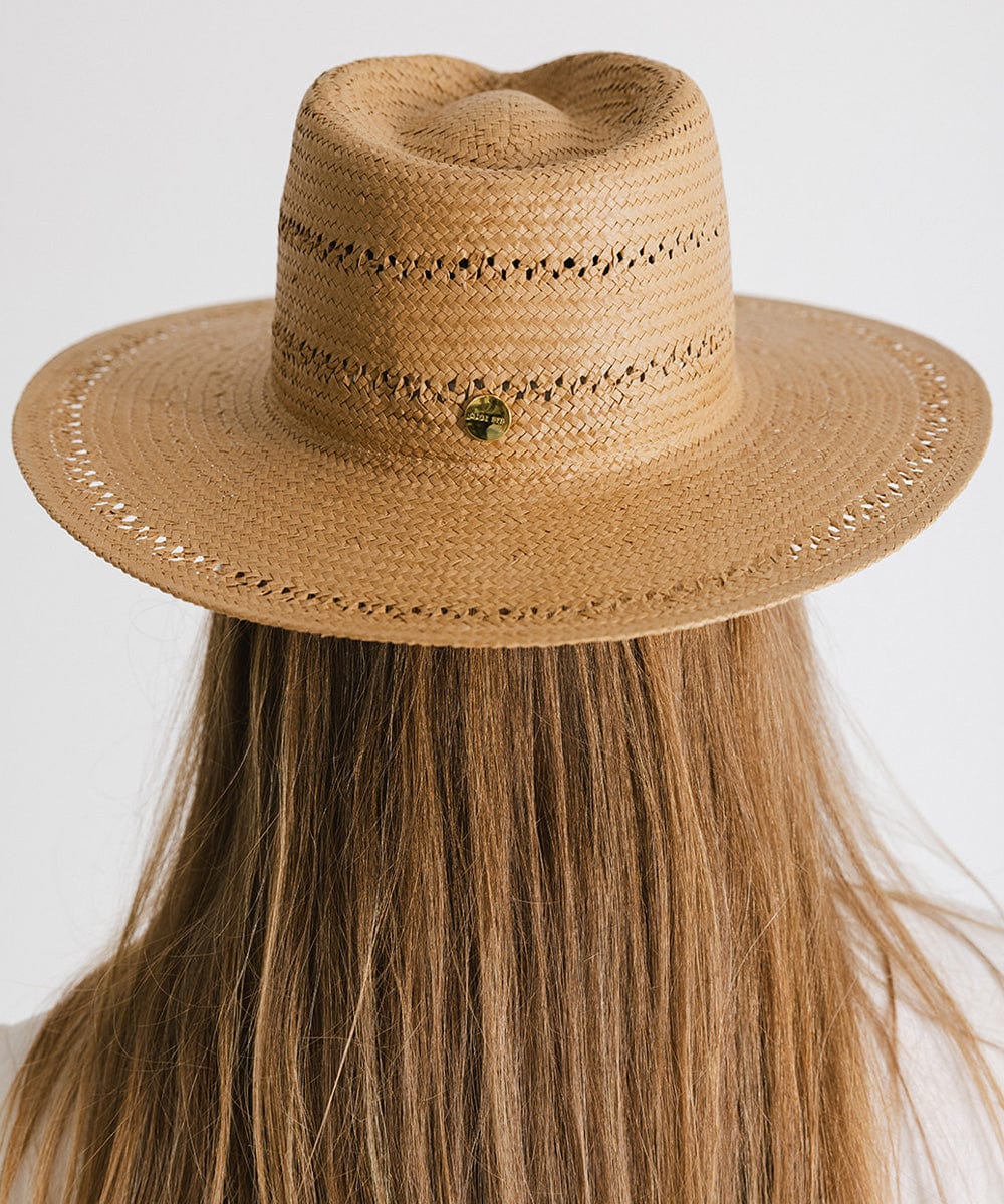 Woman with long hair wearing a honey colored teardrop straw fedora hat facing behind against a plain background #color_honey