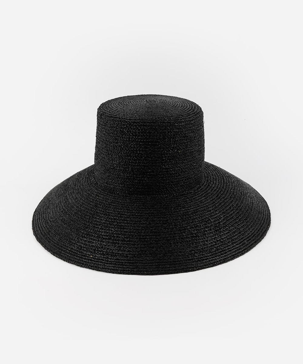 A black oversized raffia straw bucket hat with a wide brim on a plain background #color_black